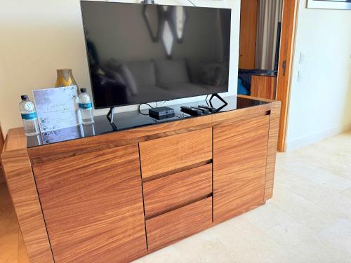 a large flat screen tv on a wooden entertainment center at Luxury Oceanview 2BR La Cruz de Huanacaxtle in Cruz de Huanacaxtle