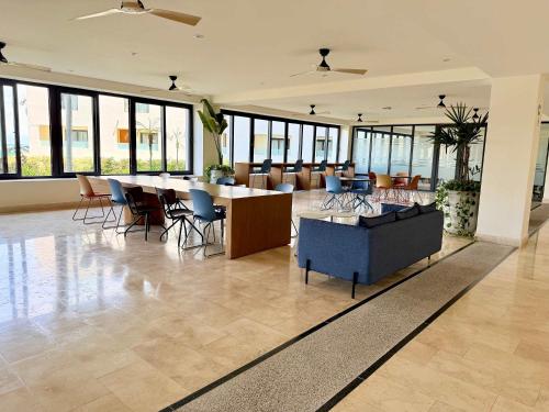 a lobby with a table and chairs in a building at Luxury Oceanview 2BR La Cruz de Huanacaxtle in Cruz de Huanacaxtle