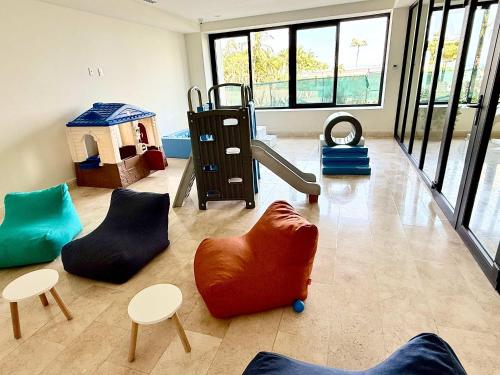 a childrens play room with chairs and a slide at Luxury Oceanview 2BR La Cruz de Huanacaxtle in Cruz de Huanacaxtle