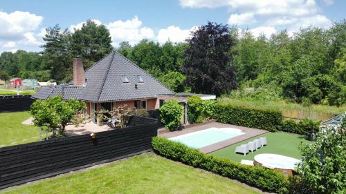 an aerial view of a house with a swimming pool at Forest Villa with shared pool & Eco Wellness in Zeewolde