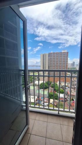 a balcony with a view of a city at De Luxe, Standard and Studio Suites -The Breeze Residences-close to Airport,Mall of Asia, US Embassy in Manila