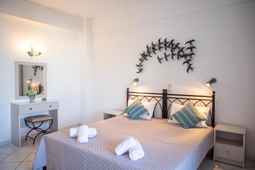 a bedroom with a bed with towels on it at Sunrise Studios in Megalochori