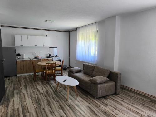 a living room with a couch and a table at House Mila in Korenica