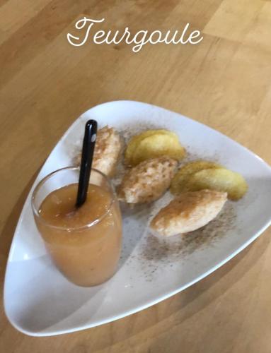 a plate of food with a drink and some snacks at Le CLOS D'ETRETAT in Les Loges