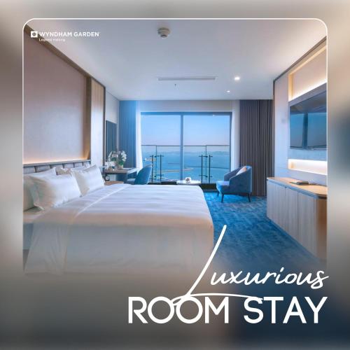 a bedroom with a bed and a room with a view at Wyndham Garden Legend Halong in Ha Long