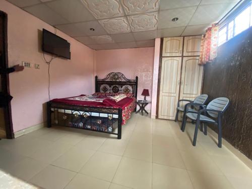 a bedroom with a bed and a table and chairs at 2 Bedrooms innara Rooms Bhurban A1 in Bhurban