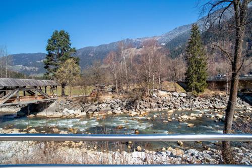 a bridge over a river next to a mountain at Apart Annabell in Habichen