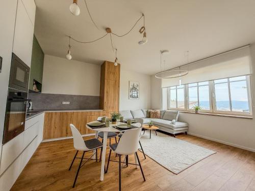 a kitchen and living room with a table and chairs at Apartmány 144 in Liberec