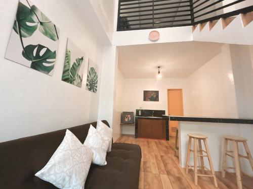 a living room with a couch and a bar at Orchid Bed and Breakfast in Galicias
