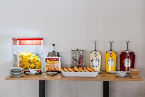 a table with hot dogs and drinks on a counter at O7 Colombo in S'Illot