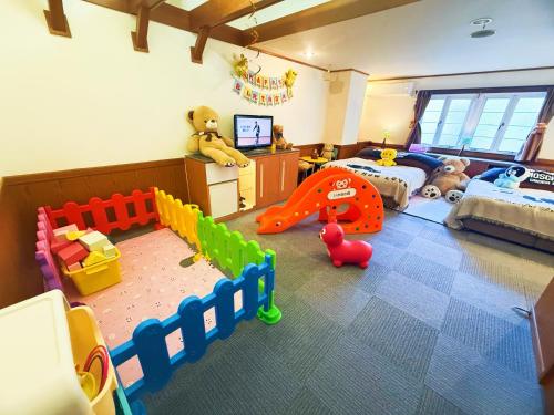 a room with a childs bedroom with a bed and toys at Ikaho no mori Kids Paradise in Ikaho