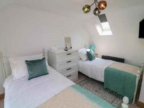 a bedroom with two beds and a dresser at Buzzard Barn in Lincoln
