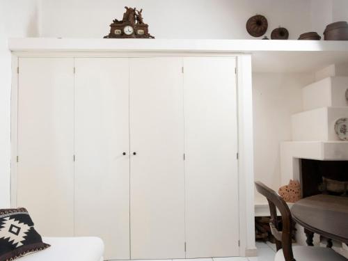 a living room with white cabinets and a fireplace at La Dimora del Re in Erice