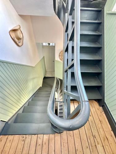 - un escalier en colimaçon dans une maison avec toboggan dans l'établissement Grande maison familiale - Vue latérale mer - Proximité immédiate de la Plage principale de Berck, à Berck-sur-Mer