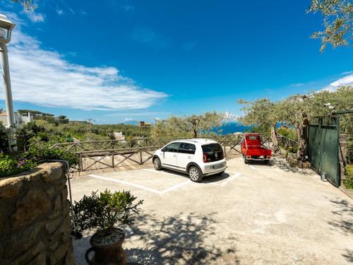 a white car parked in a parking lot at Villa Carolina Sorrento Private Heated Pool and Sea View in Sorrento