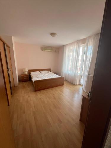 a bedroom with a bed and a wooden floor at Fort Noks with sea view in Elenite