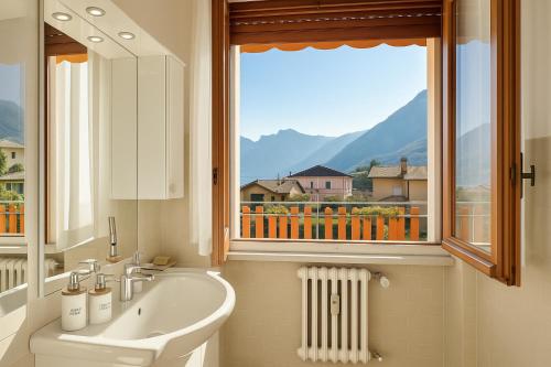 a bathroom with a sink and a window at Lake View Apartment - Parking Included in Oliveto Lario