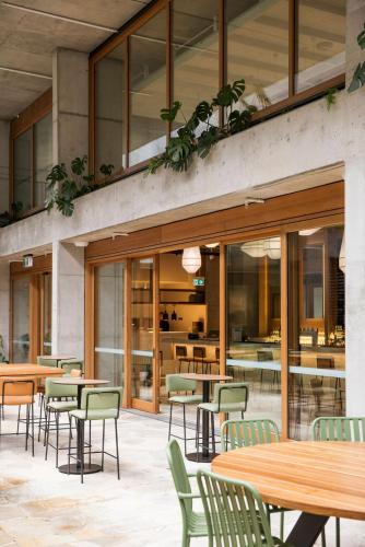 a restaurant with tables and chairs and a cafeteria at lyf Bondi Junction Sydney in Sydney