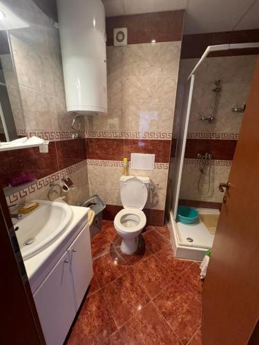 a bathroom with a toilet and a sink and a shower at Fort Noks with sea view in Elenite