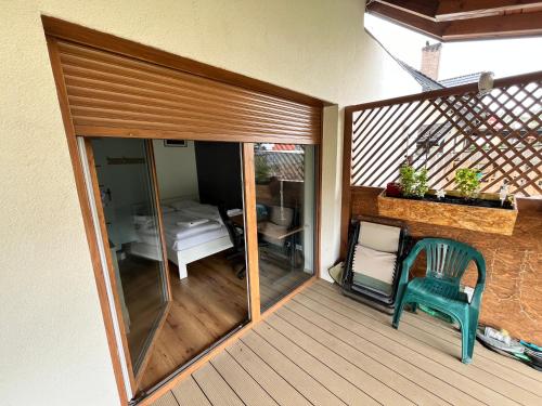 a balcony with a sliding glass door with a bed at Wakacje Mazury, Willa Ametyst, cisza , ptasi śpiew GRZYBY , RYBY in Szczytno