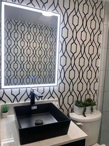 a bathroom with a black sink and a mirror at The Spot in Nanaimo
