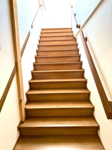 a stairway with wooden steps in a building at Hotel Bílý Beránek Kralovice in Kralowitz