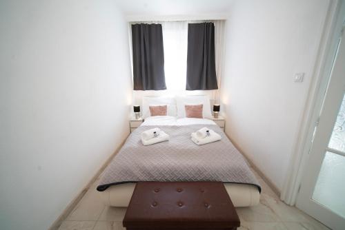 a small bedroom with a bed with towels on it at Free Parking- Hungaria Charm 4PPL Wifi TV AC in Pusztavacs