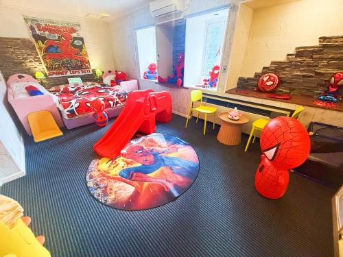 a childrens bedroom with a bed and a slide at Ikaho no mori Kids Paradise in Ikaho