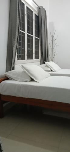 a bed in a room with a window at annies inn homestay in Cochin