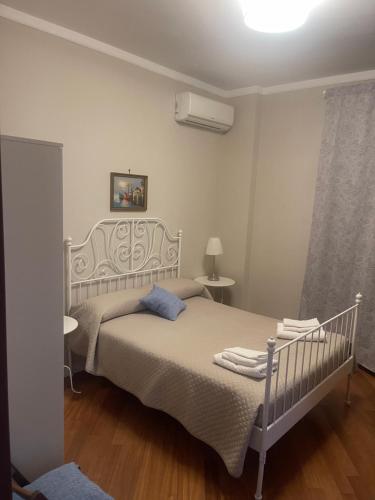 a bedroom with a white bed and a white ceiling at La Terrazza Quisisana Sorrento Coast in Castellammare di Stabia