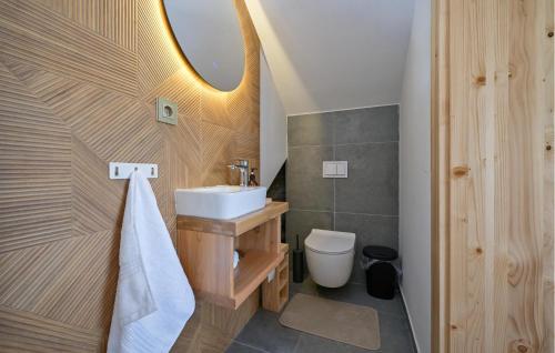 a bathroom with a sink and a toilet and a mirror at Beautiful Home In Maglenca With Sauna in Maglenča
