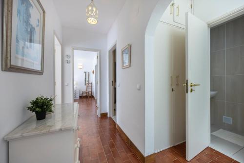 een hal met witte muren en een tegelvloer bij Casa Maresia da Salema in Salema