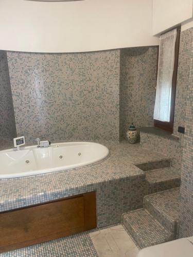 a bathroom with a tub and some stairs at La Terrazza Quisisana Sorrento Coast in Castellammare di Stabia