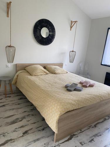 a bedroom with a bed with a mirror on the wall at Guesthouse proche bordeaux Parking in Eysines