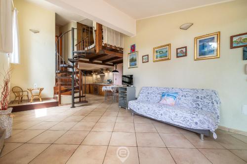 a living room with a couch and a staircase at Villa Mary in Simius