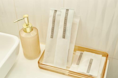 a container of paper towels and a bottle of soap at Baan Ping Tara Tropical Pool Villa and Scooter in Ban Khlong Son