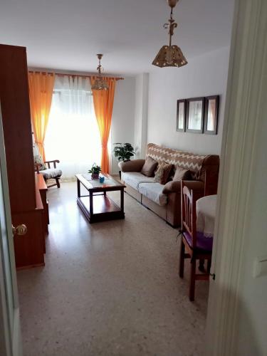 a living room with a couch and a table at Casa Niebla in Vejer de la Frontera