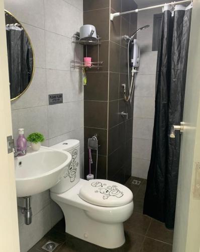 a bathroom with a toilet and a sink at Meritus Suites - 8pax in Perai