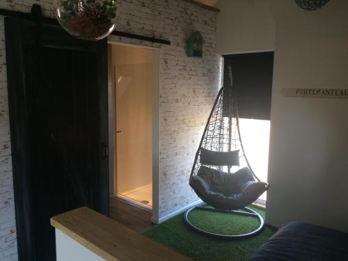 a room with a hammock in the corner of a room at De Weegbrug in IJzendijke