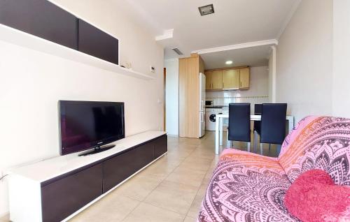 a living room with a flat screen tv and a couch at Awesome Apartment In Bellreguard in Bellreguart