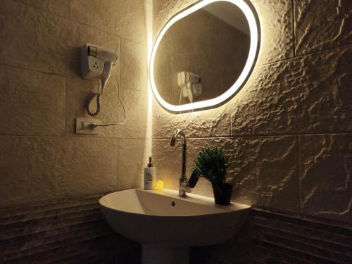 a bathroom with a sink and a mirror on the wall at Royal central home Cairo in Cairo