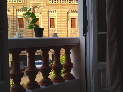 a window with a potted plant on a ledge at Royal central home Cairo in Cairo