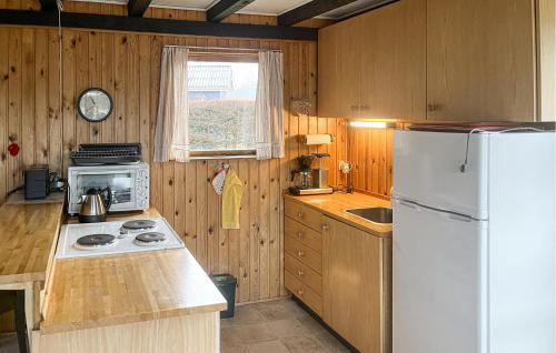 a kitchen with a white refrigerator and a sink at 1 Bedroom Nice Home In Fårvang in Fårvang