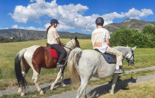 two people riding on horses in a field at Awesome Home In Bellaffaire With Wifi in Bellaffaire