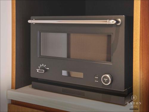 a microwave oven sitting on top of a shelf at BATON SUITE Okinawa-kourijima in Nakijin
