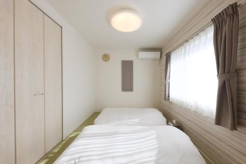 Postel nebo postele na pokoji v ubytování Angler’s Resort Awajishima