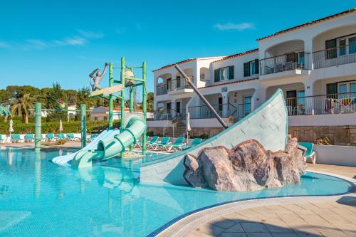 a swimming pool with a water slide in a resort at Seth Mestral & Llebeig in Santo Tomás