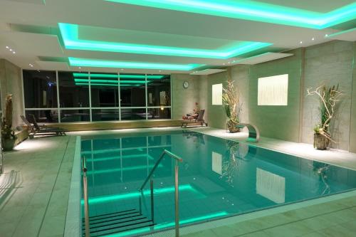 a swimming pool with blue lights in a building at Panorama Whg 25, 2 OG in Cuxhaven