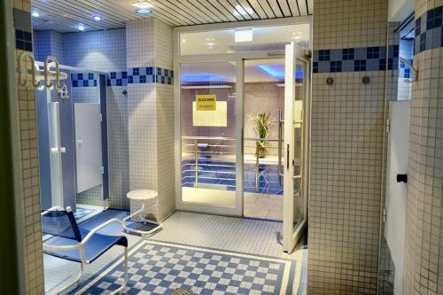 a bathroom with a shower with a chair in it at Panorama Whg 25, 2 OG in Cuxhaven