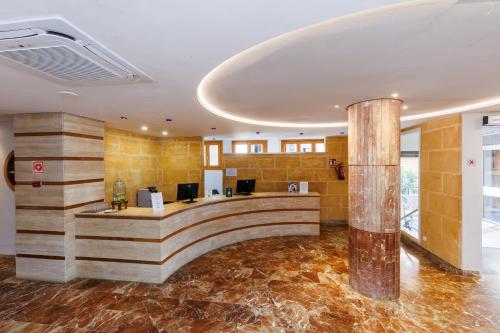 a lobby with a reception desk in a building at O7 Colombo in S'Illot